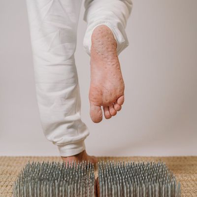 Man's feet on a yoga mat, showing stability and grounding.