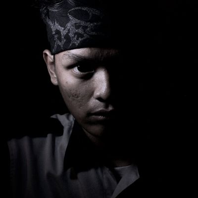 Silhouette of a person in a powerful stance against a dark background.